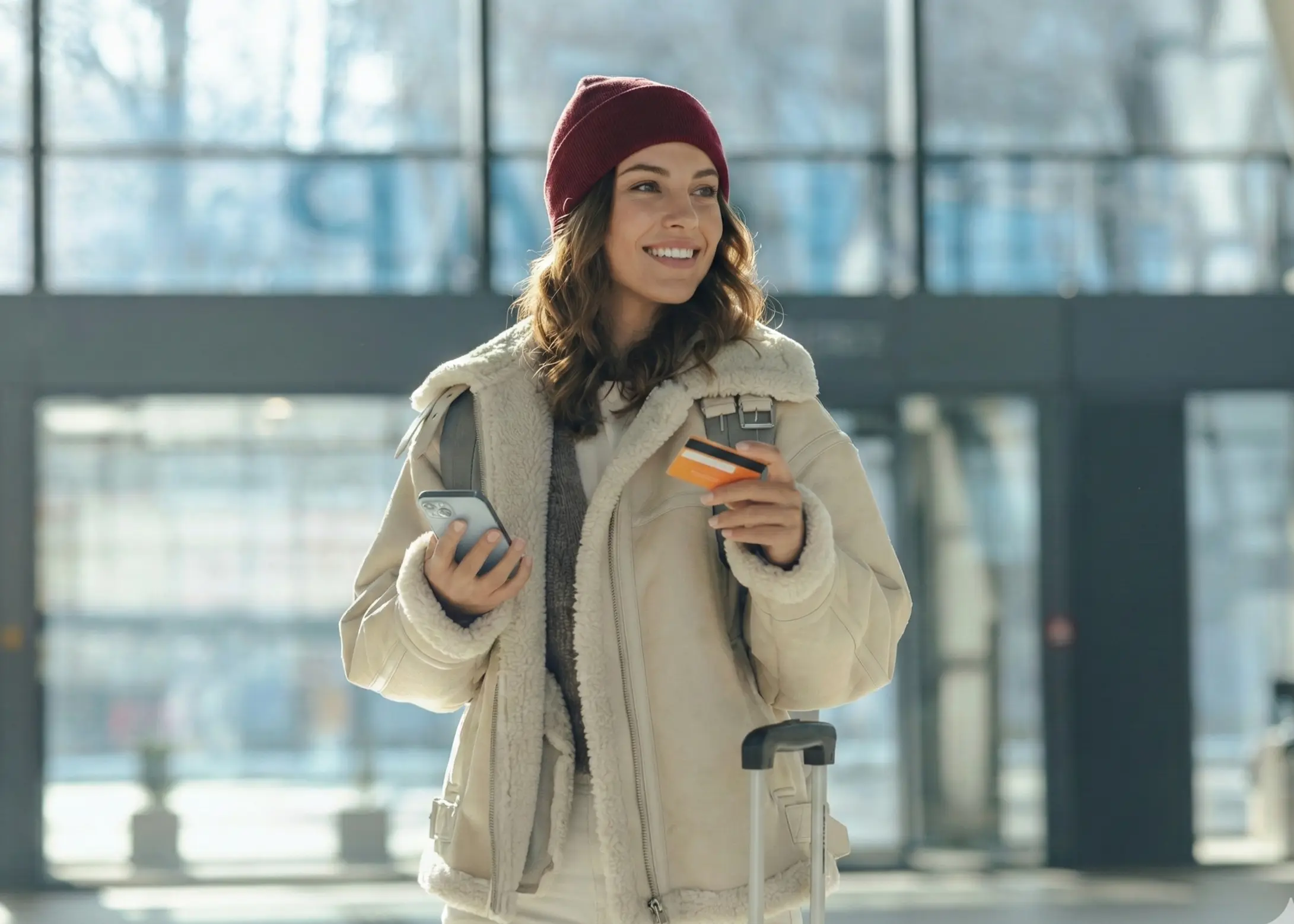 Smiling woman at a desk with a quote about using credit card travel and purchase insurance wisely to save money and boost peace of mind.